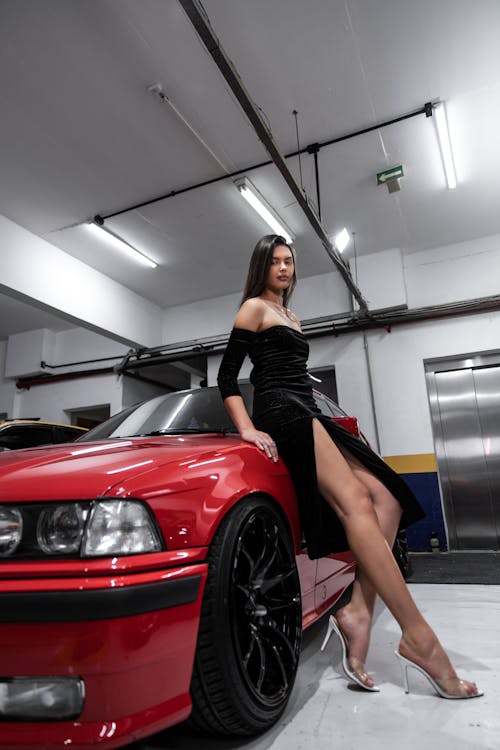 Woman in Black Dress Standing by Red BMW E36