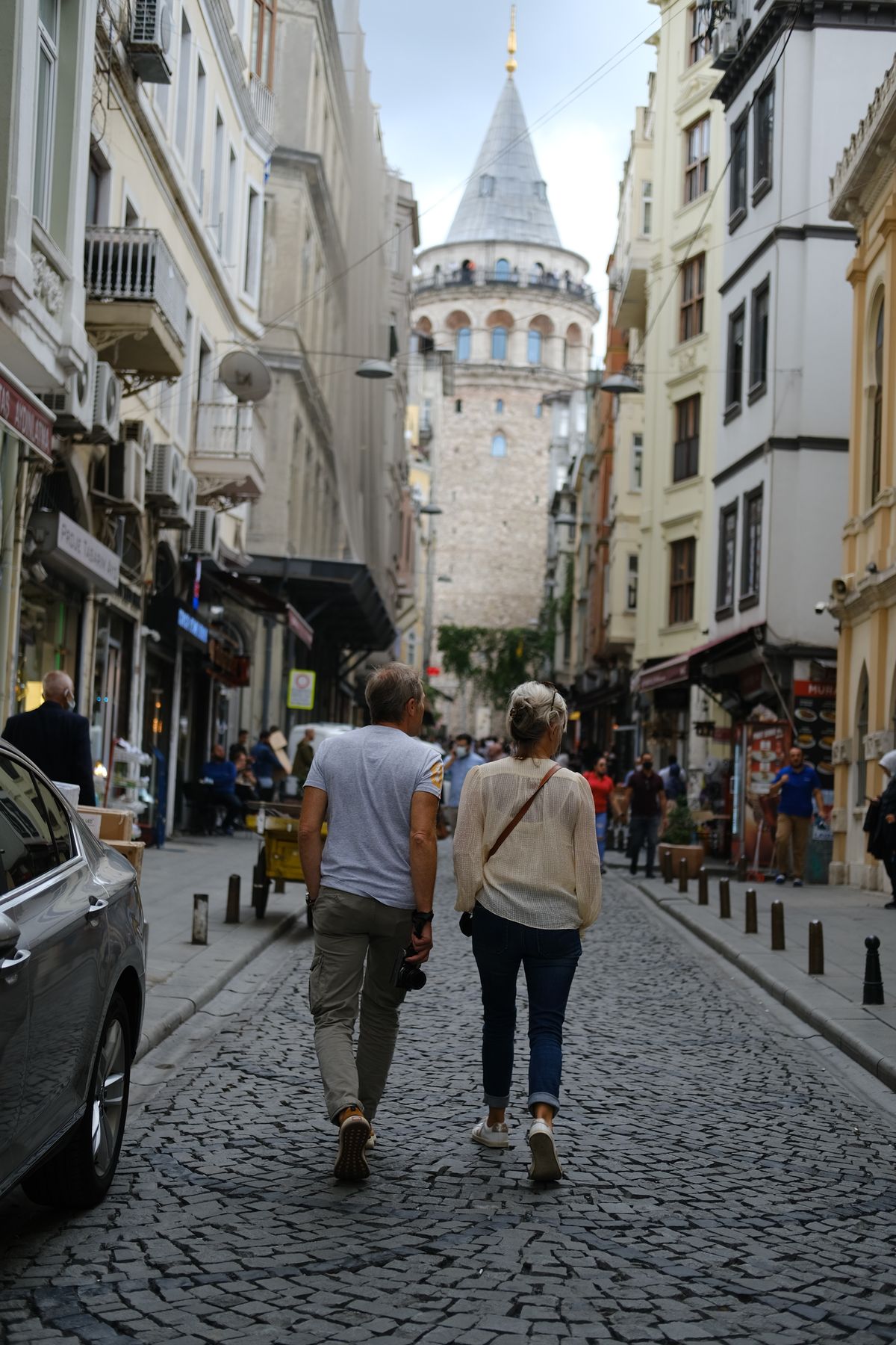 Couple walking toward Galata Tower in Istanbul, Turkey