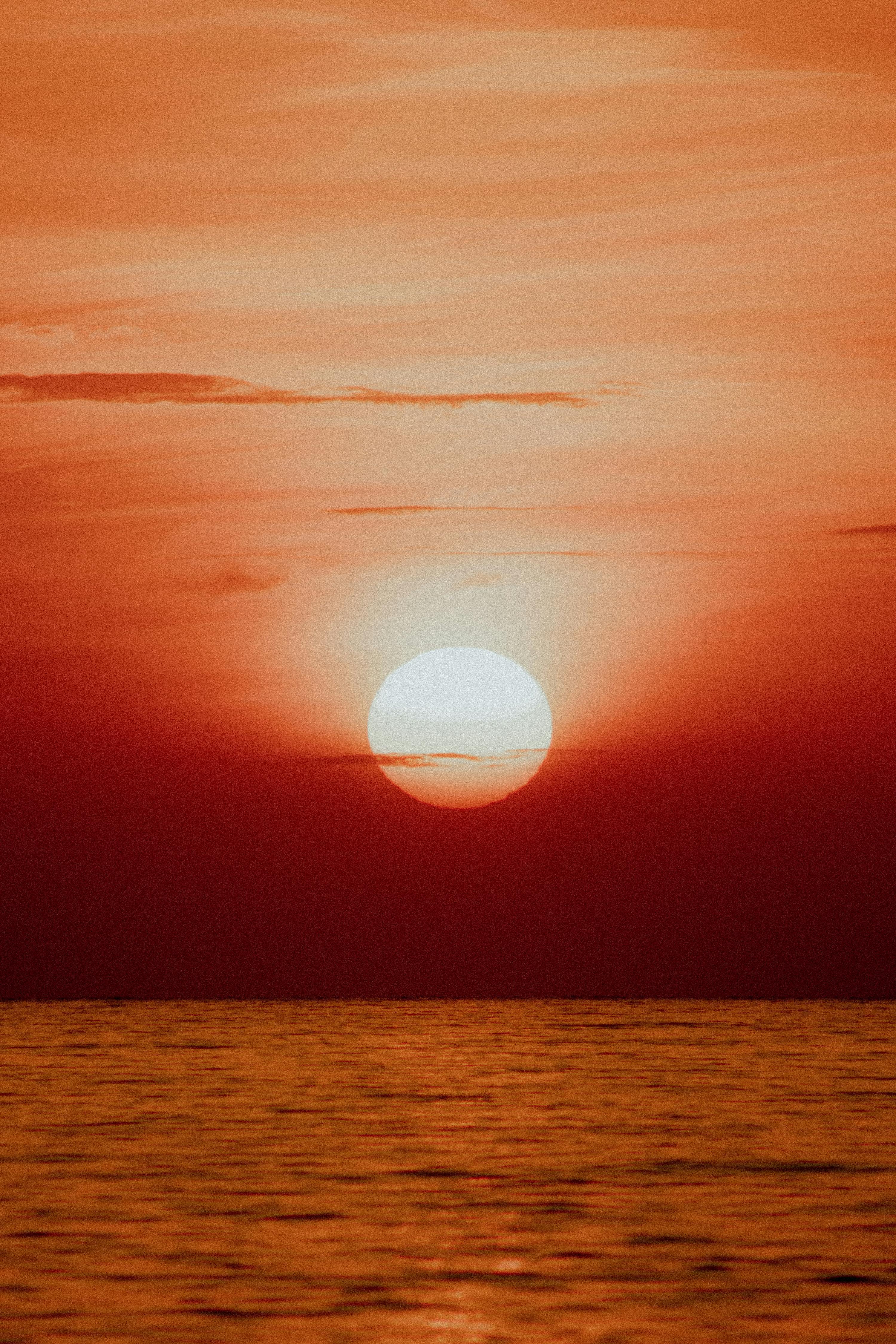 Beautiful sunset over the ocean in Panama with vibrant red hues and calm waters.