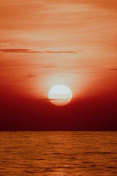 Beautiful sunset over the ocean in Panama with vibrant red hues and calm waters.