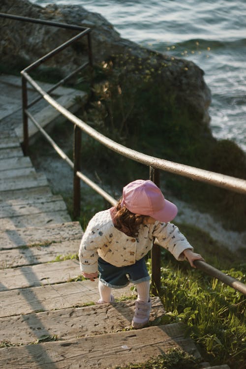 Little Girl Walking up the Stairs on the Seashore