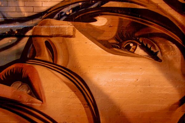 Painted mural of a face on brick — Eduardo Romero on Pexels