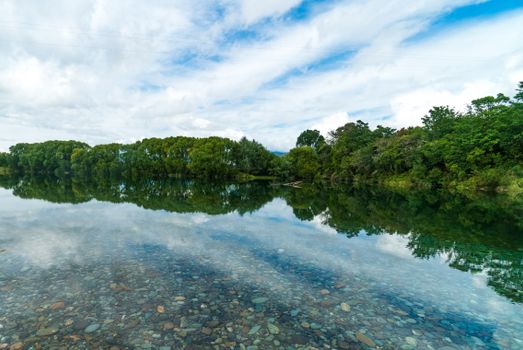 Pebble Seen though Clear Water of a Placid Lake