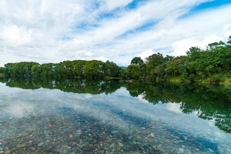 Pebble Seen Though Clear Water Of A Placid Lake