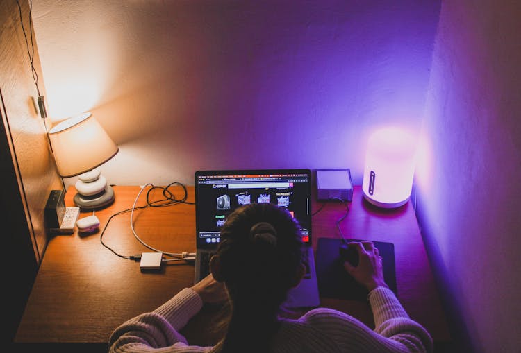 Woman Browsing The Internet In A Dark Room