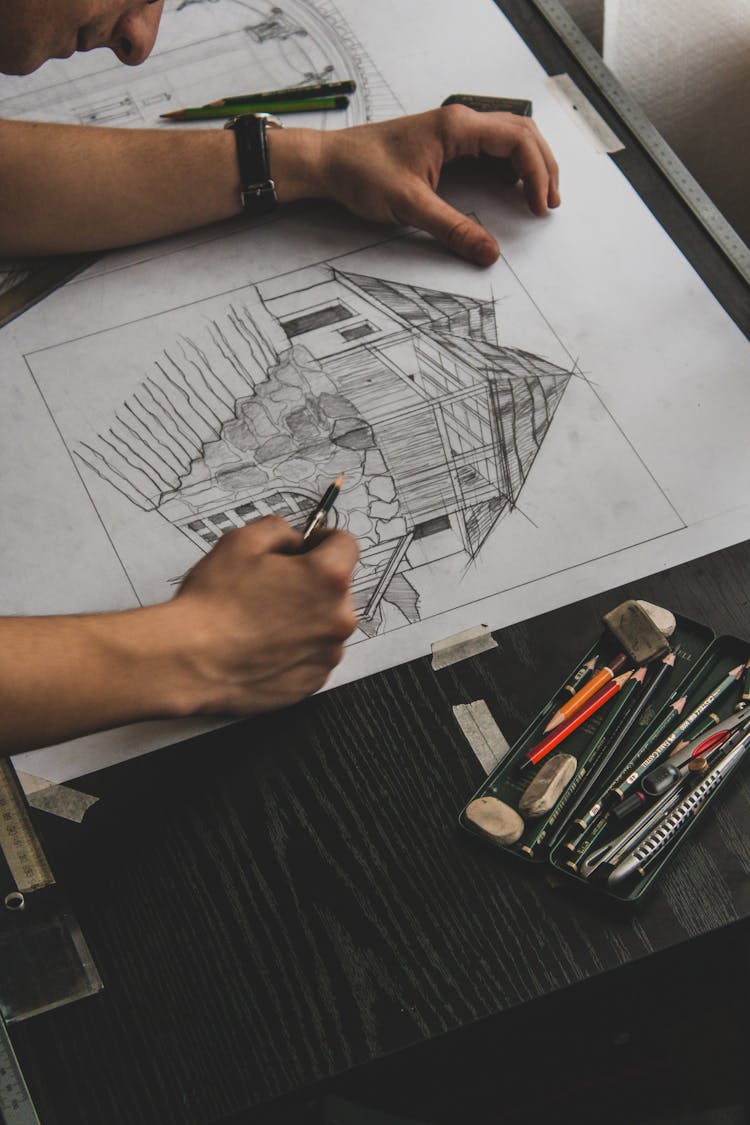 Man Drawing A Sketch Of A House