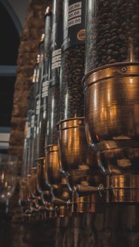 A detailed view of coffee dispensers showcasing coffee beans, perfect for café ambiance.