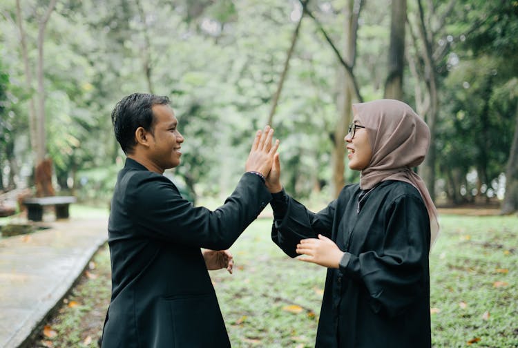 Smiling Woman And Man Clapping Hands