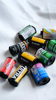 A top view photo showcasing various colorful analog film rolls on a white background.