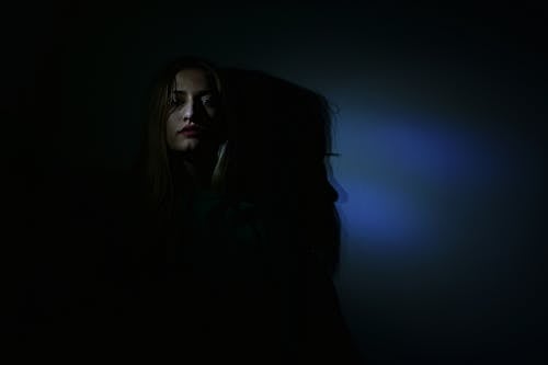 Free Photo of Woman in Dark Room Stock Photo