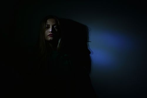 Blue light in a dark room, photo by Diana on Pexels
