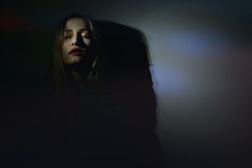 Photo of Woman Leaning on Wall