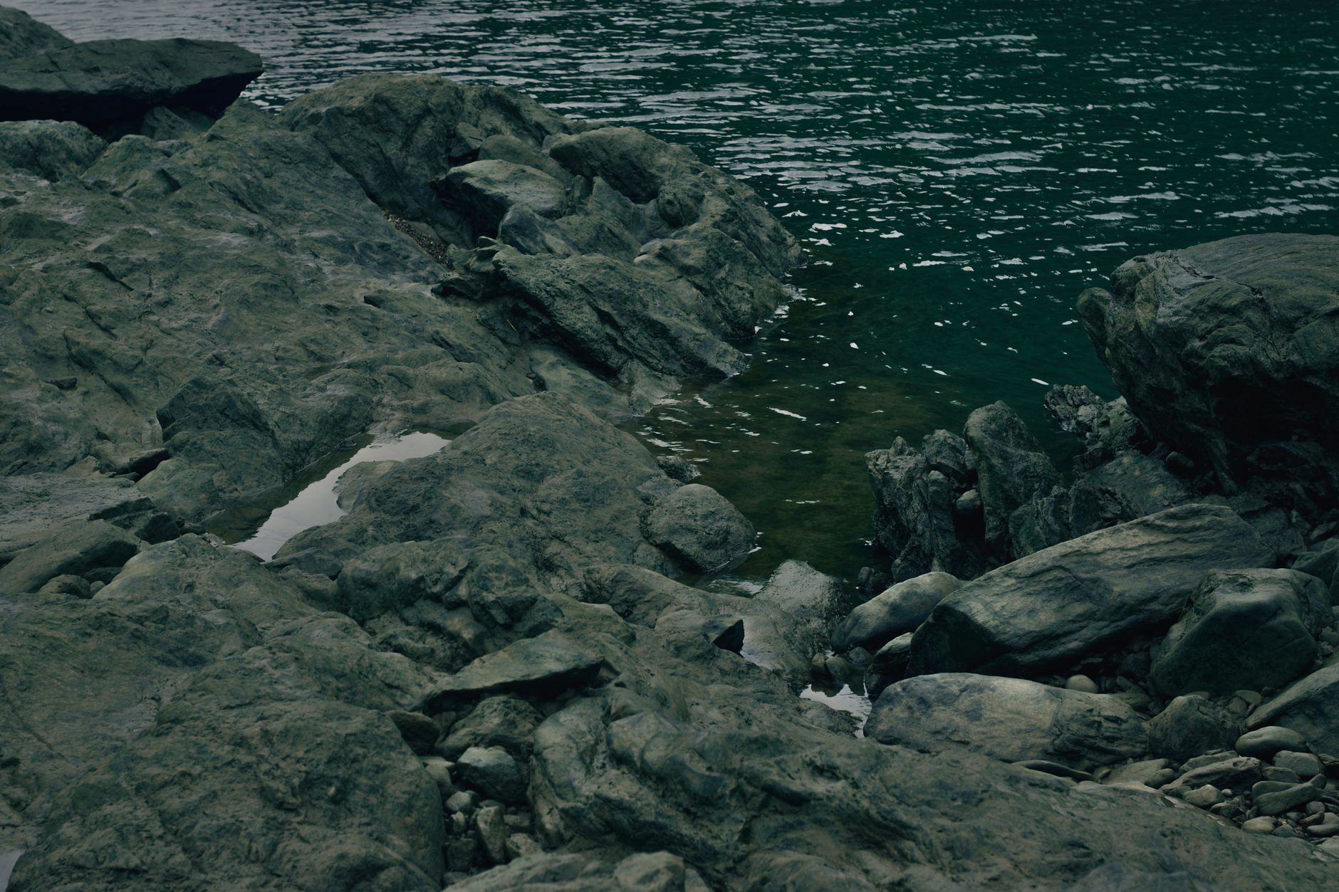 Explore a tranquil rocky shoreline with gentle waves meeting the coast.. explore, tranquil, rocky