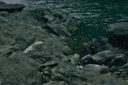 Explore a tranquil rocky shoreline with gentle waves meeting the coast.. explore, tranquil, rocky