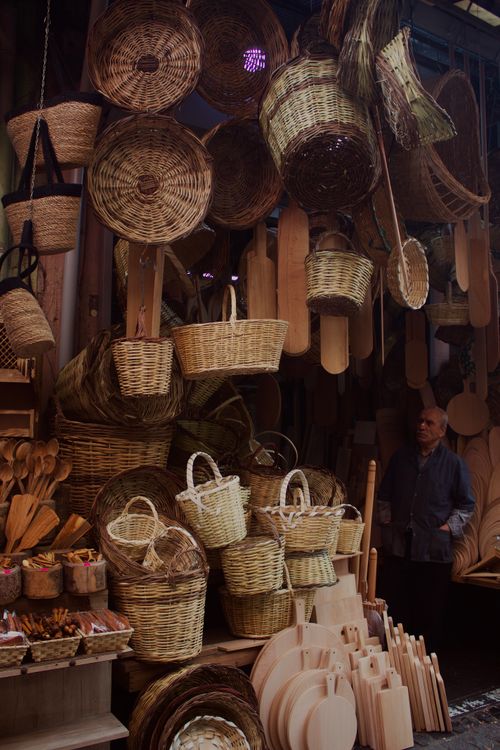 Free A charming display of hanging woven baskets and wooden items at an outdoor market stall. Stock Photo
