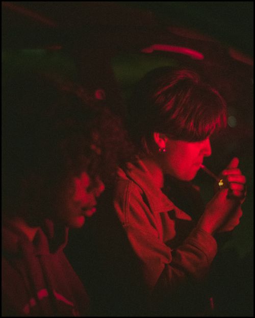 Free Two adults in a dimly lit setting with red lighting, emphasizing a dramatic mood. Stock Photo