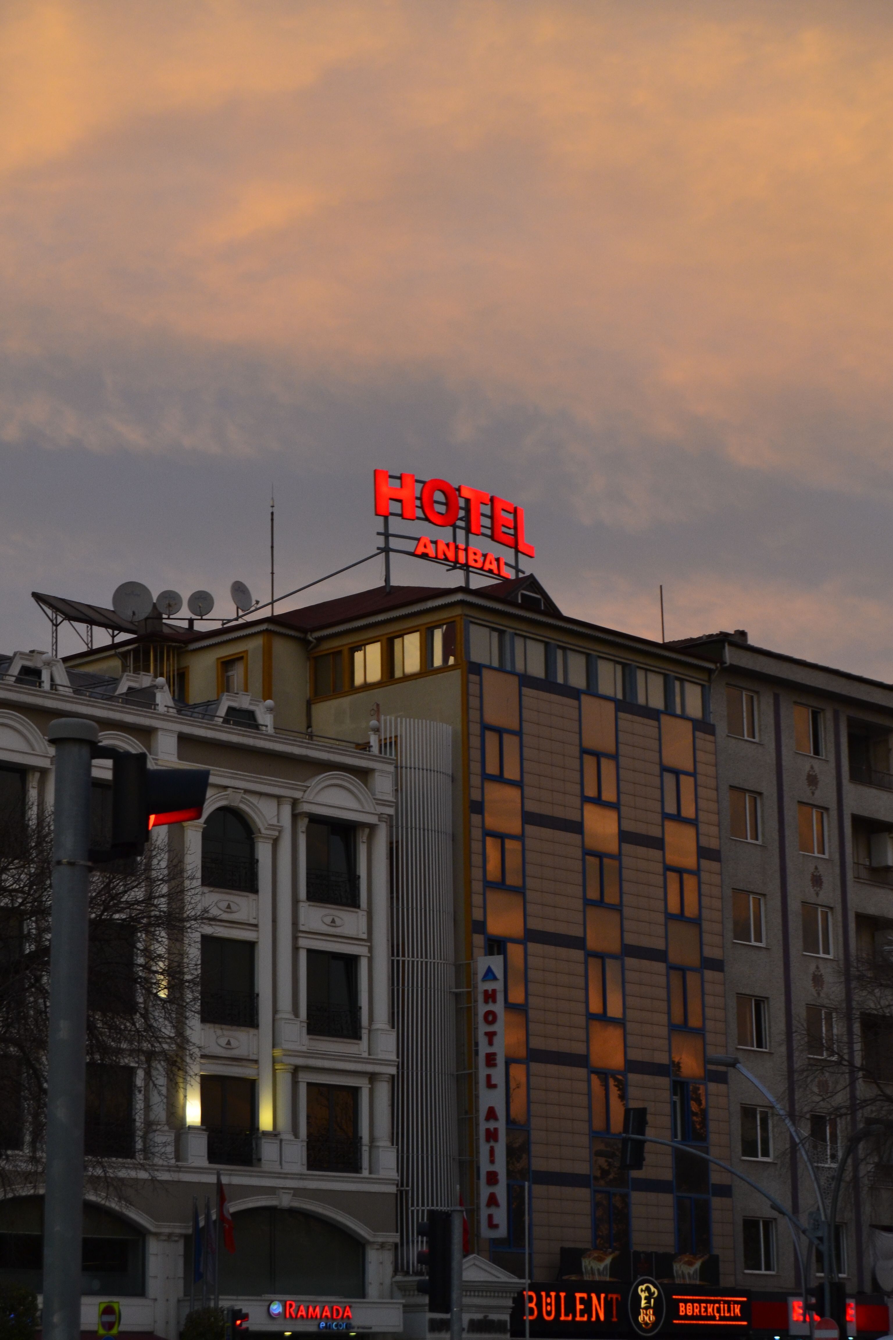 Atmospheric view of Hotel Anibal in Gebze, Kocaeli at sunset with urban architecture and cloudy sky.