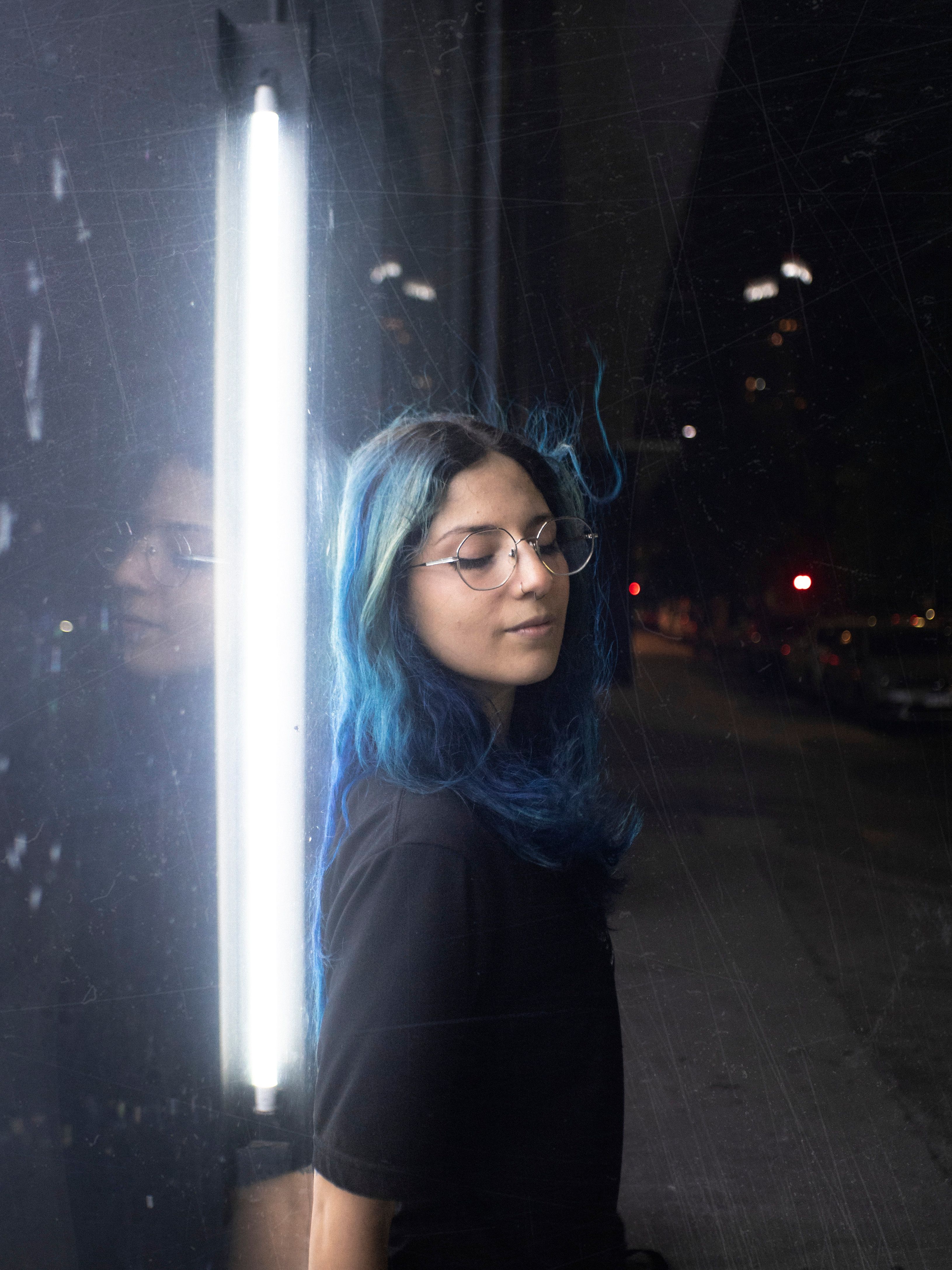 Woman with Blue Hair Wearing Eyeglasses by the Neon · Free Stock Photo