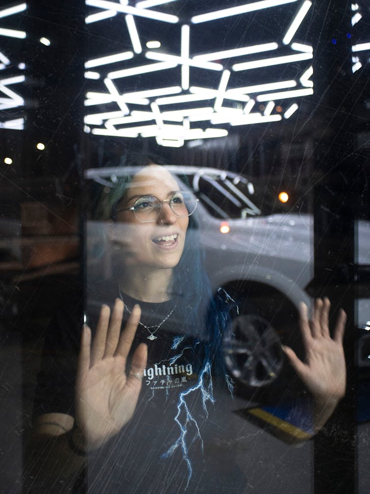 Car And Woman Reflection In Window