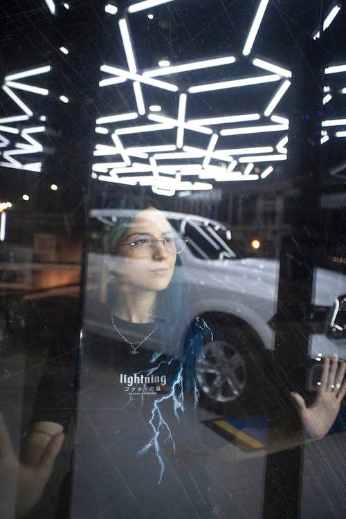 Woman Looking at Car Behind a Window 