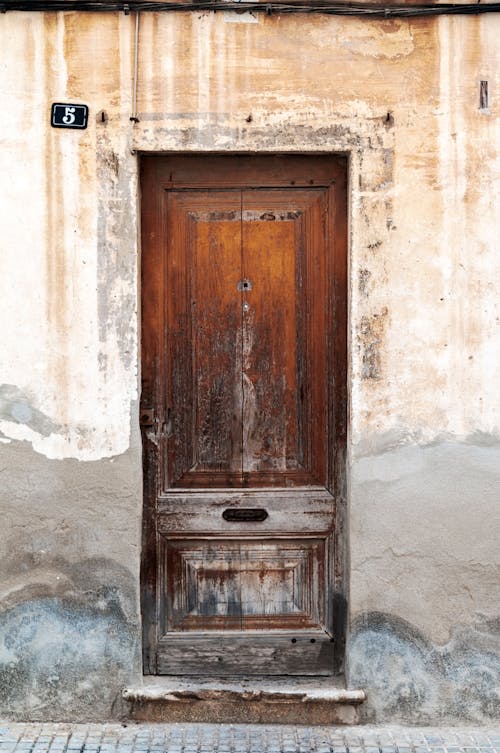 Wooden Door in Damaged Building Wall