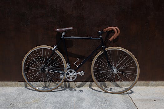 A classic vintage bicycle leaning against a rusty urban wall, captured in sunlight.
