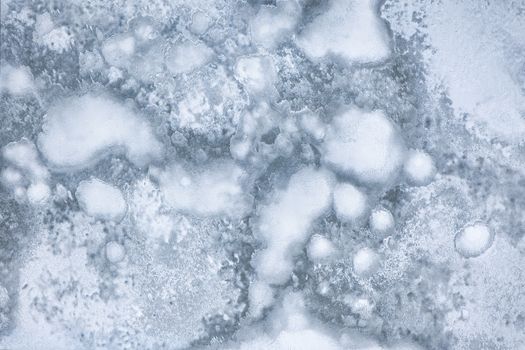 Intricate frost patterns on icy surface captured in winter outdoors.
