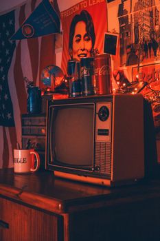 Retro-inspired room featuring a vintage television and nostalgic elements with warm ambient lighting.