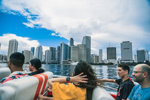 People on Motorboat on Sea Coast in City