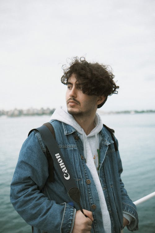 Man in Jean Jacket Posing by Water