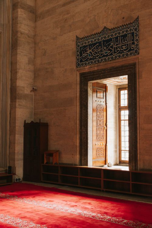 Free Sunlit interior of Suleymaniye Mosque featuring traditional Ottoman architecture and ornate details. Stock Photo
