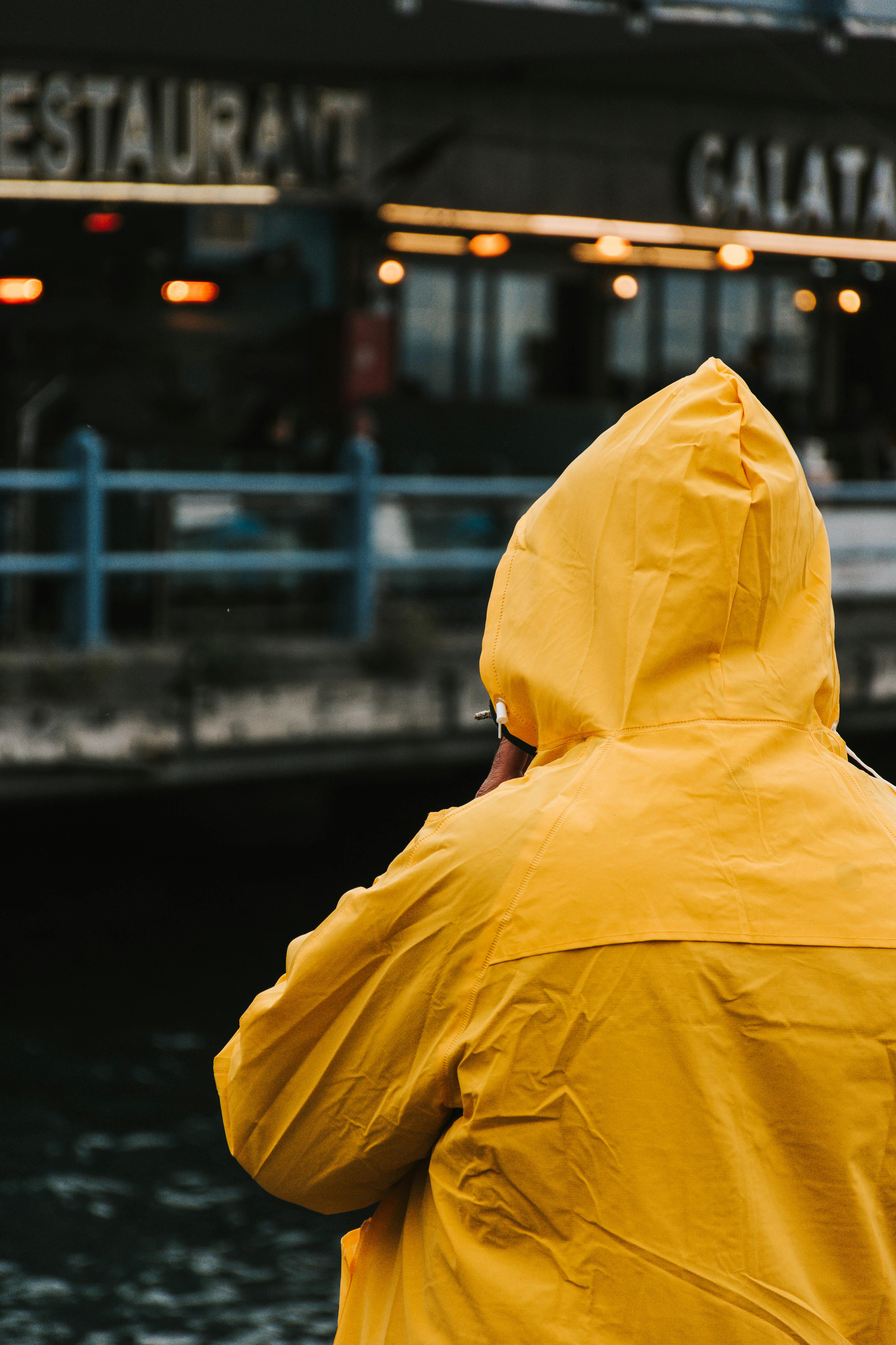 Fisherman in Yellow Raincoat near Galata Bridge · Free Stock Photo