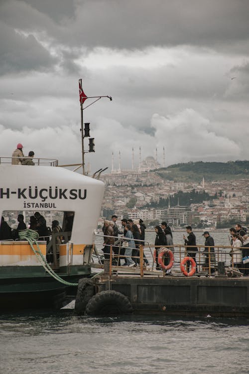 Free Passengers Boarding a Ferry Moored at a Pier, Istanbul, Turkey Stock Photo
