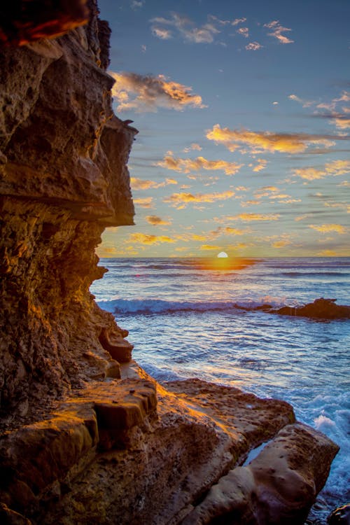 Free stock photo of beach sunset, blue water, cliffs