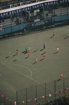 Aerial shot of a soccer game in Yahya Kemal Stadium with players in vibrant jerseys.