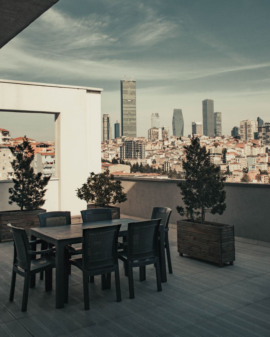 Outdoor terrace with lounge seating overlooking a city skyline — photo by Ahmet Polat on Pexels