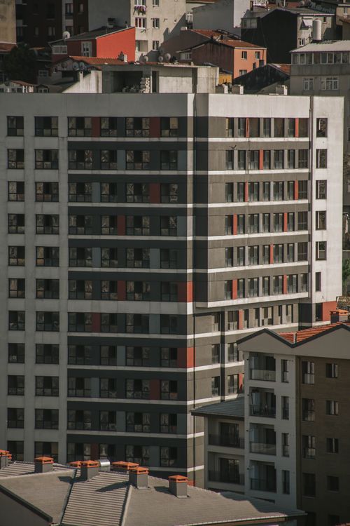 Free Tall modern apartment building in a bustling urban cityscape with contemporary design. Stock Photo