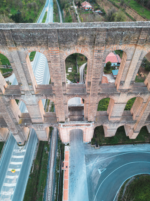 Free Drone shot showcasing the historic Carolino Aqueduct in Caserta, Italy. Stock Photo