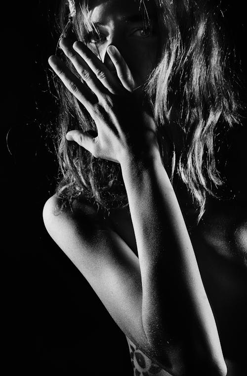 Naked Woman with Hand on Face Posing in Studio