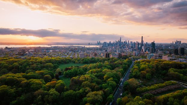 Stunning aerial panorama of New York City skyline overlooking Central Park during sunset.