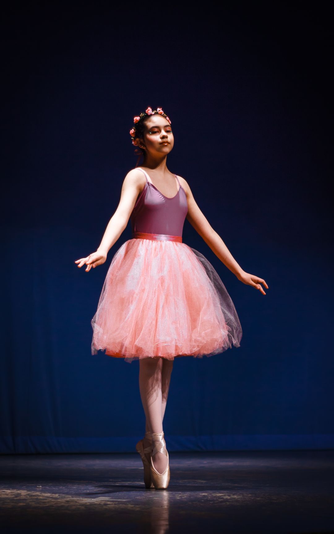 Ballerina performing on stage in a pink GlitzMotion tutu