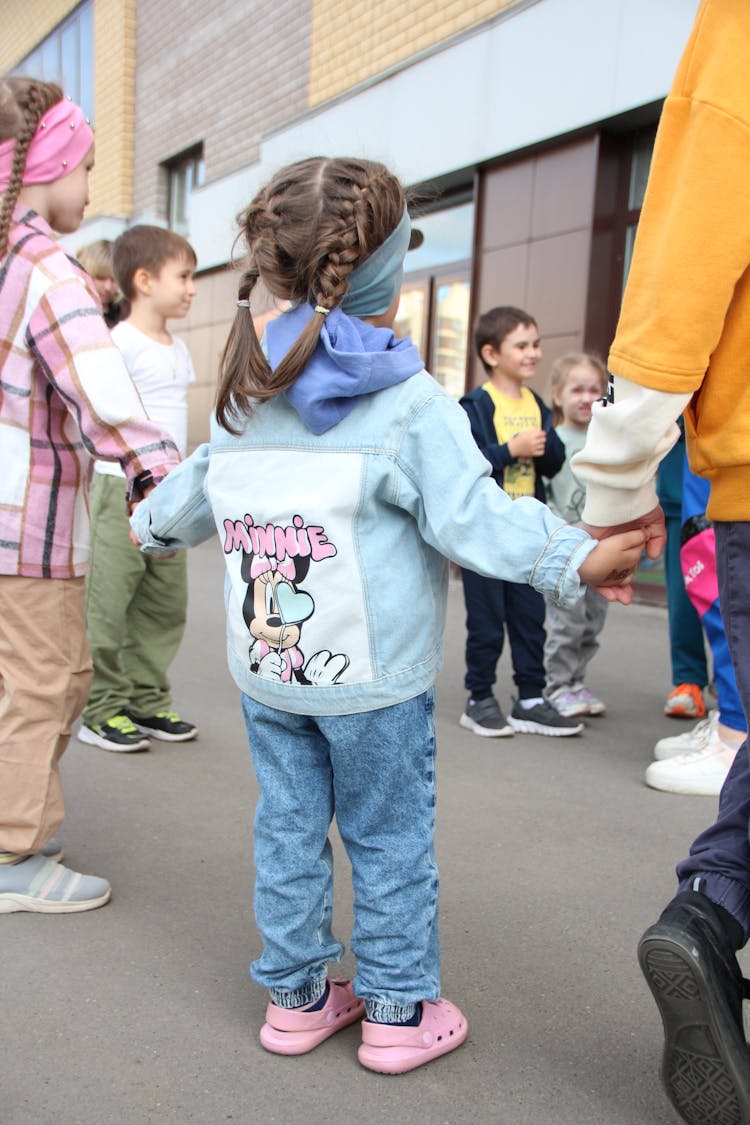 Small Children Standing In A Circle Holding Each Others Hands 