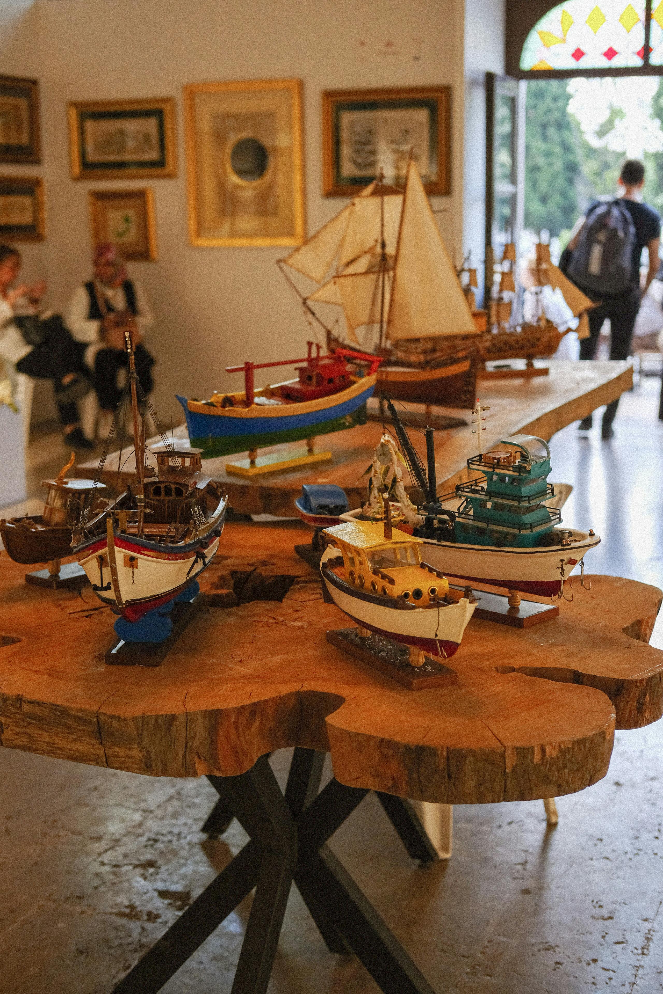 a wooden table with a model boat on it