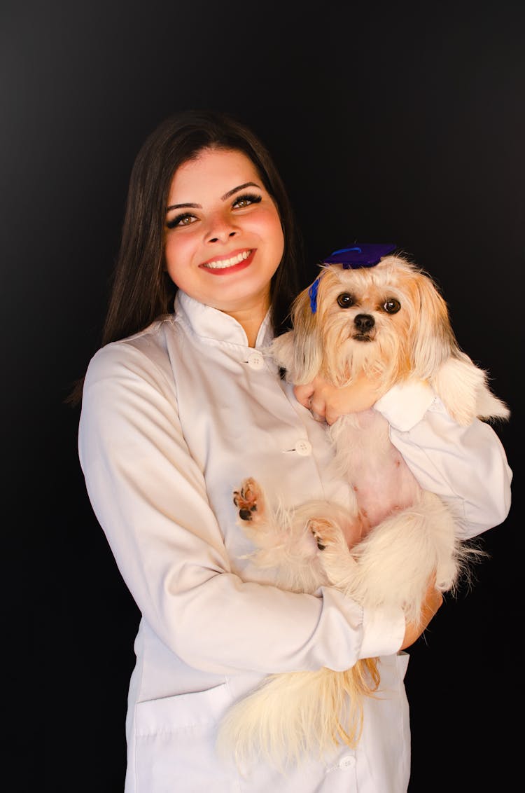 Portrait Of A Woman Holding A Dog 