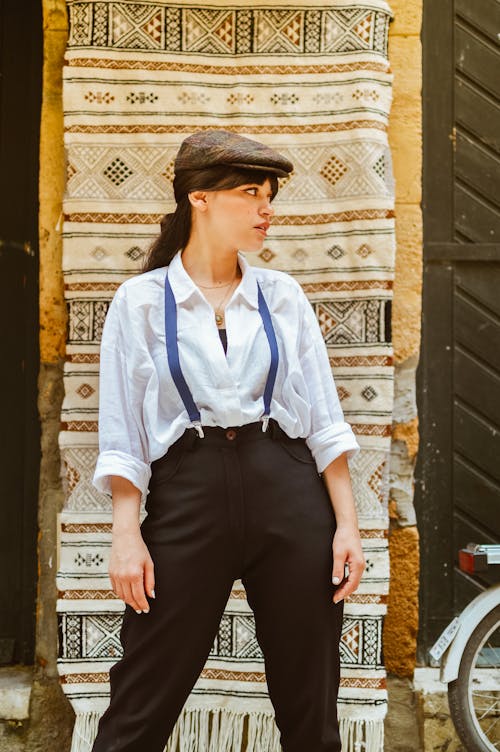 Woman in a White Shirt and Pants on Suspenders