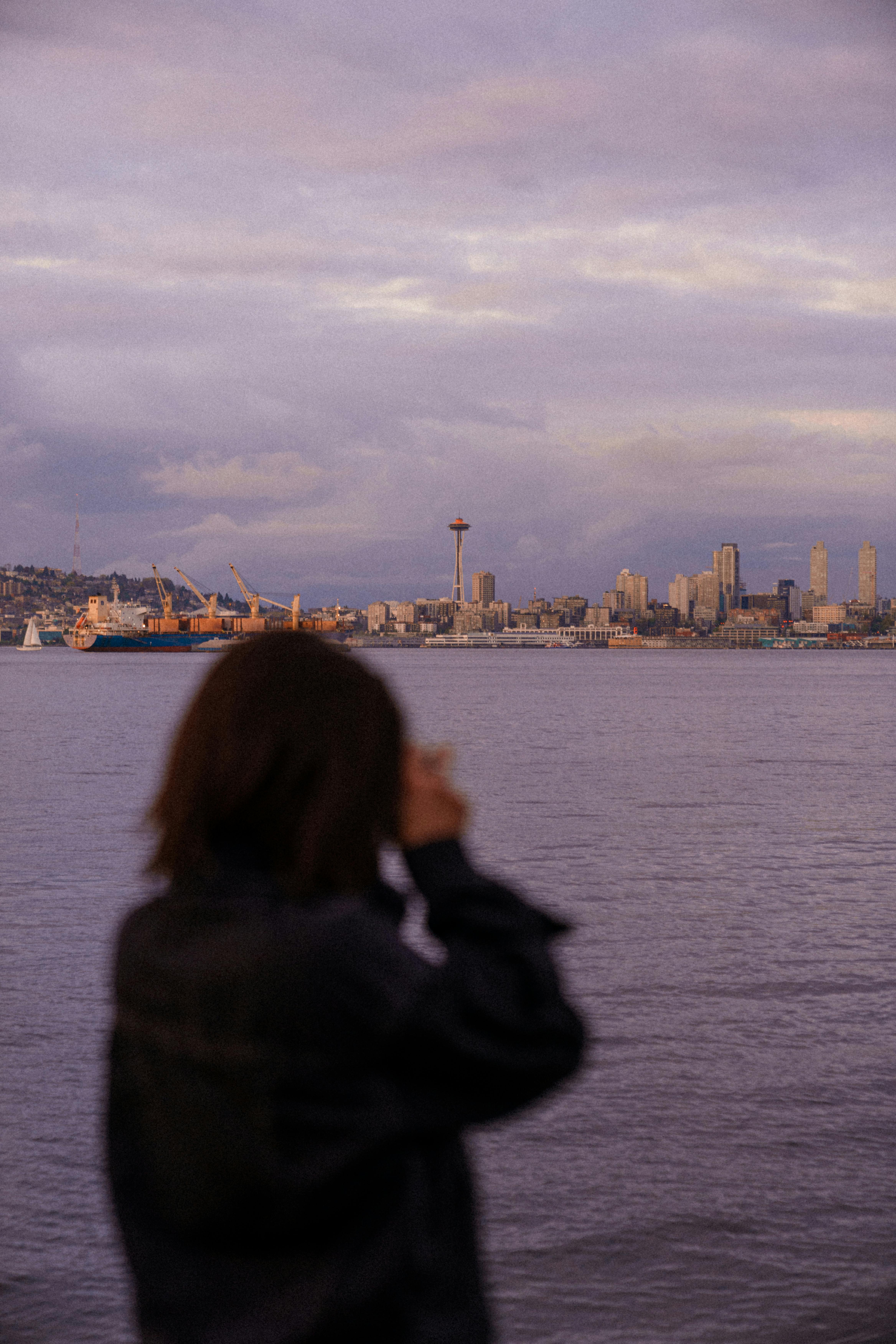 A scenic view of the Seattle skyline and Space Needle during a beautiful sunset over the water.