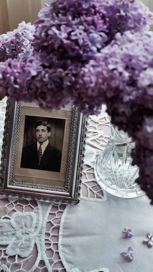 Vintage Portrait and Lilac Flowers on the Table