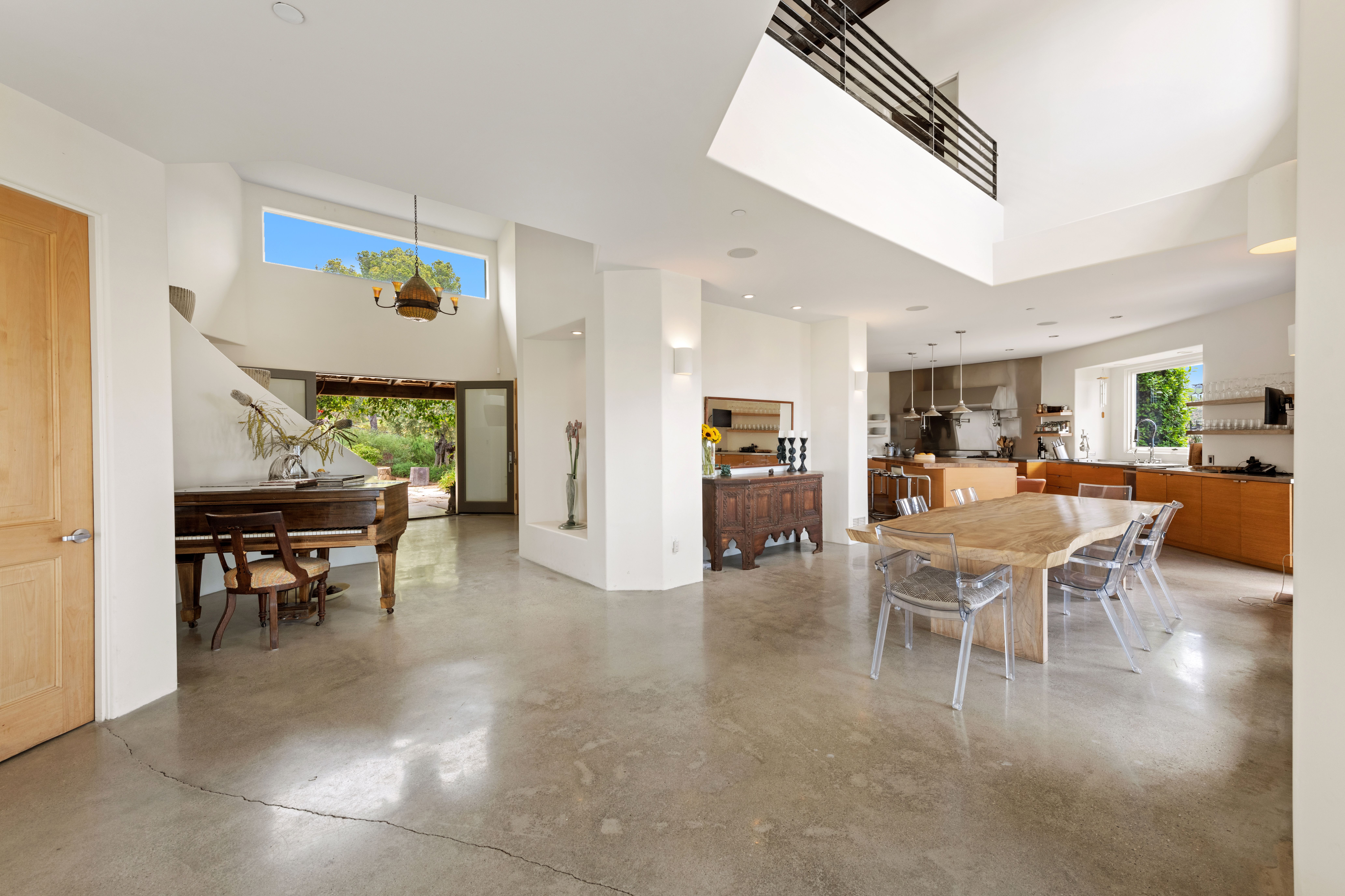 Sunlit open-plan living and dining area with neutral tones