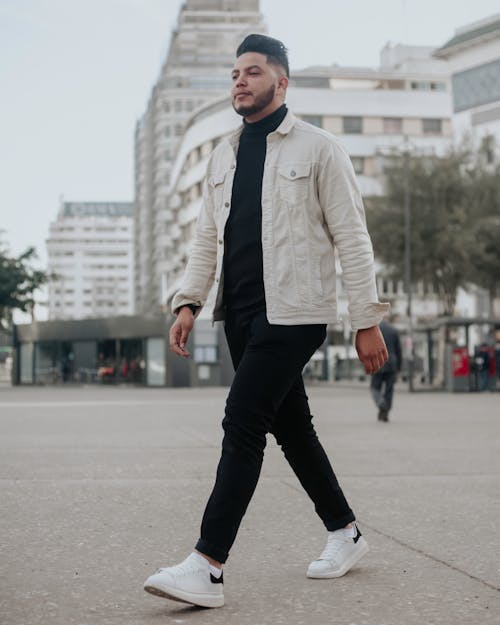 Young Man in a Fashionable Outfit Walking in City 