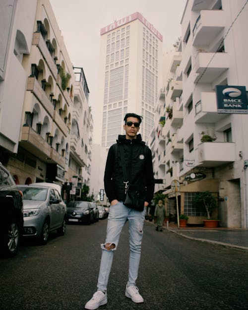 Young Man in a Trendy Outfit Standing on the Street in City 